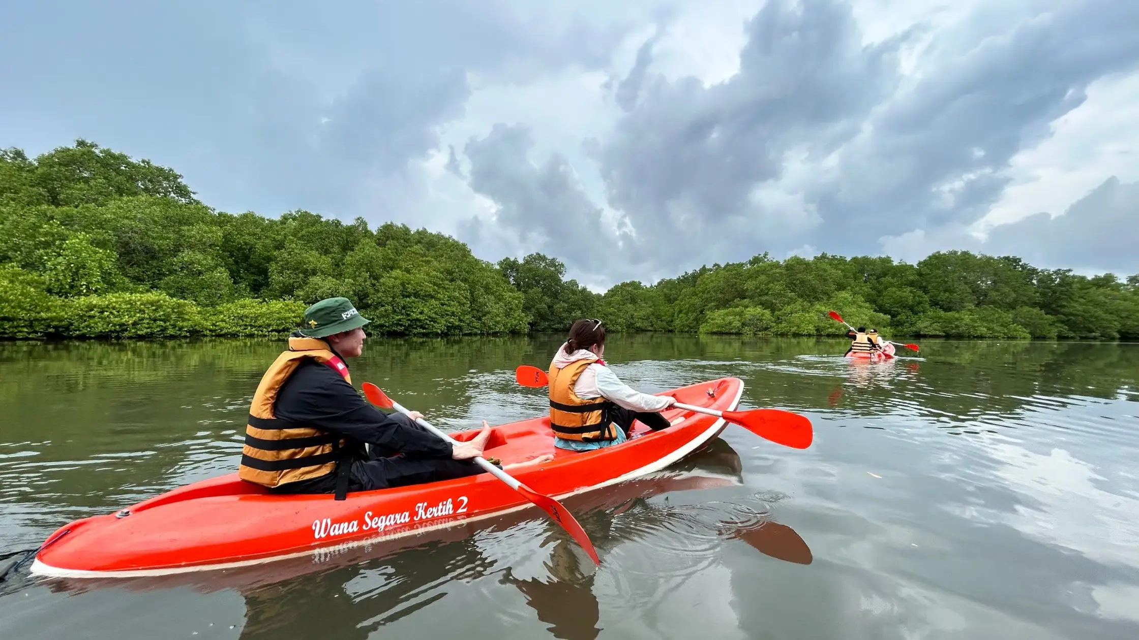 Couple canoeing through Bali mangrove forest