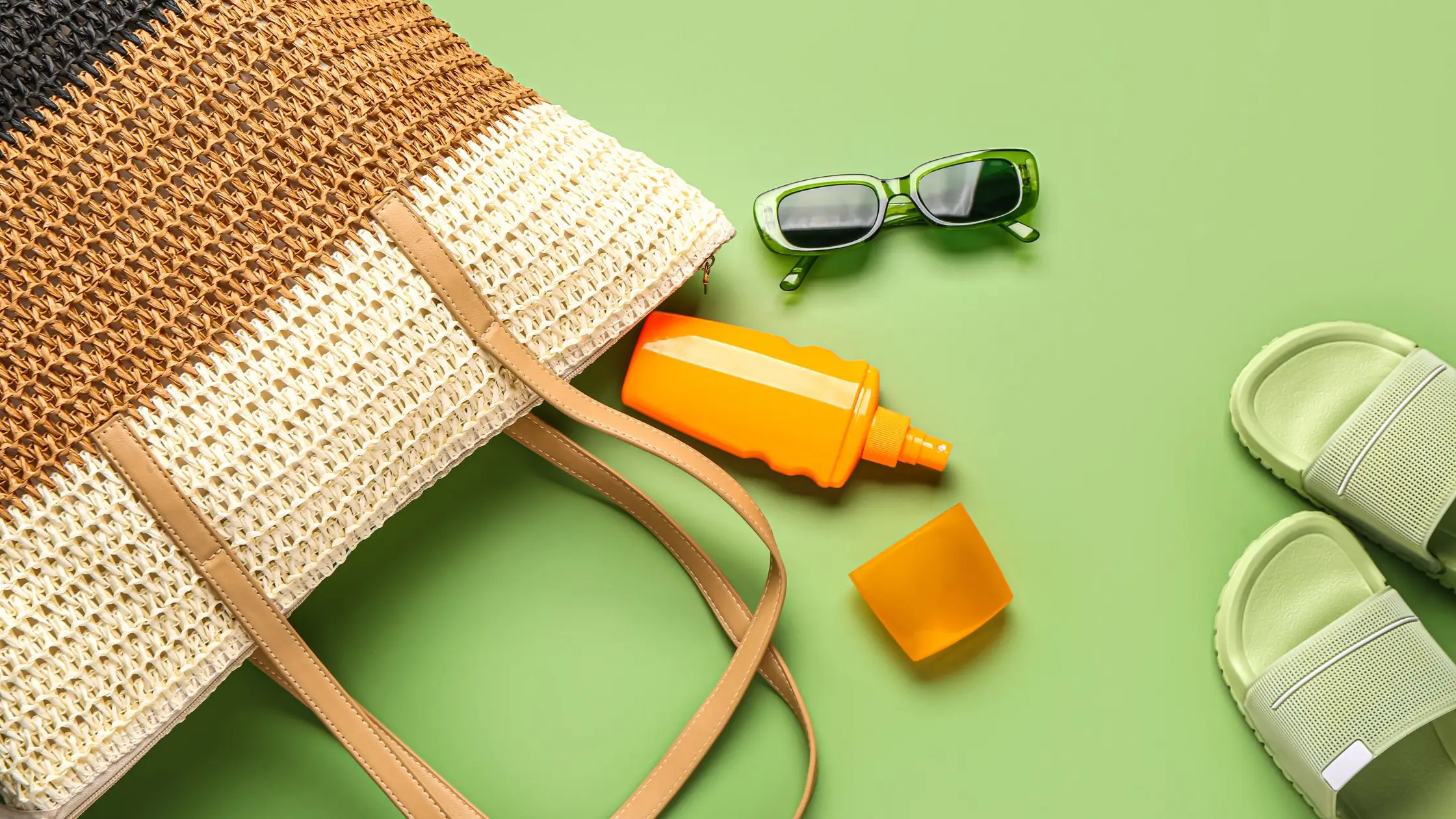 Eco travel essentials — beach bag, sunscreen, sandals, and sunglasses for sustainable Bali adventure.