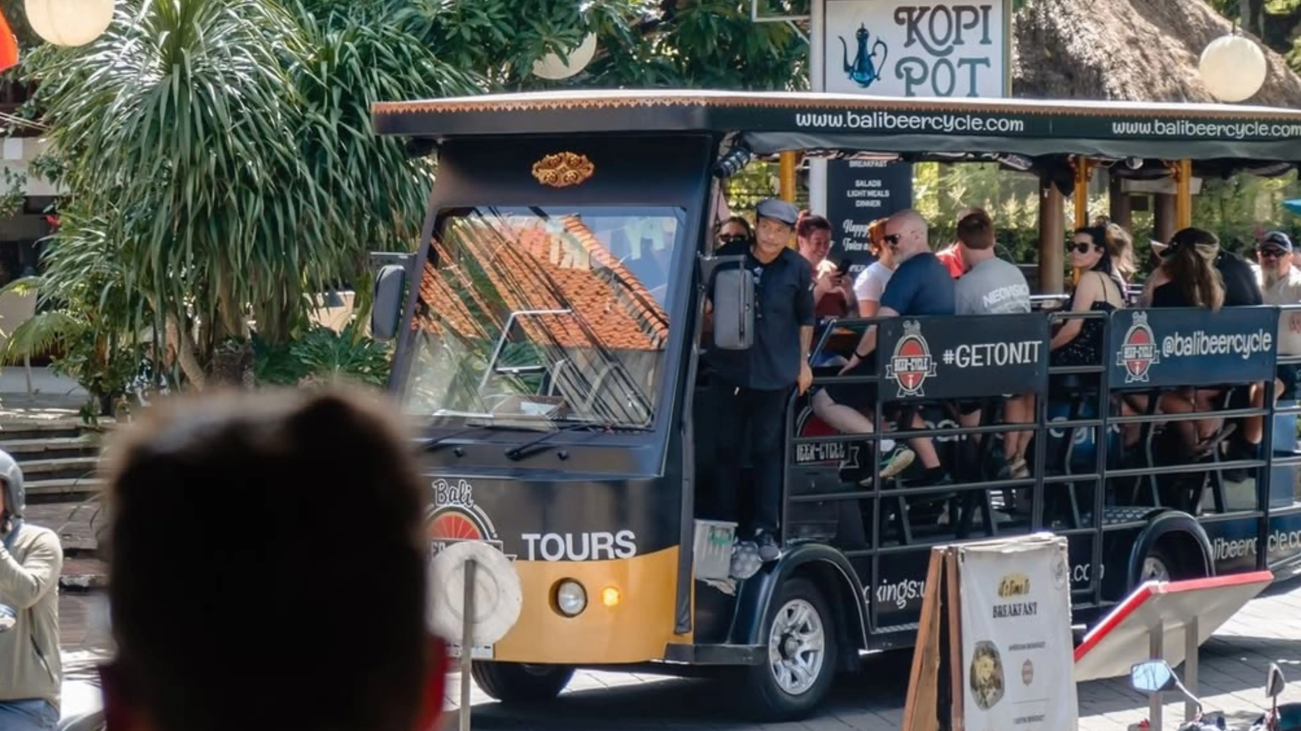 Bali beer cycle night tour with travelers sipping drinks, and socializing