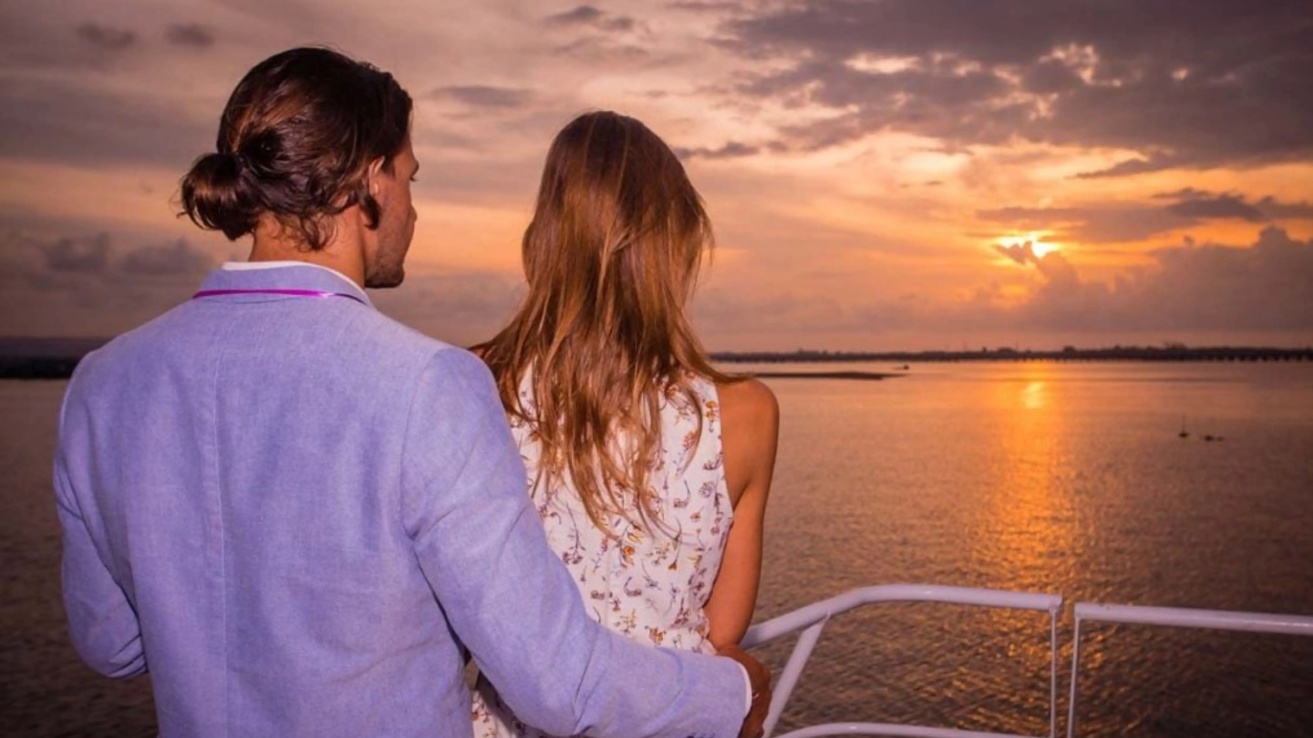 A couple enjoying panoramic ocean views during a Bali night cruise