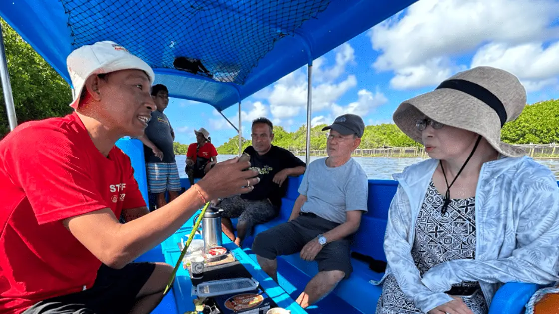Local tour guide educating travelers about Bali’s mangroves during a bali eco friendly tour