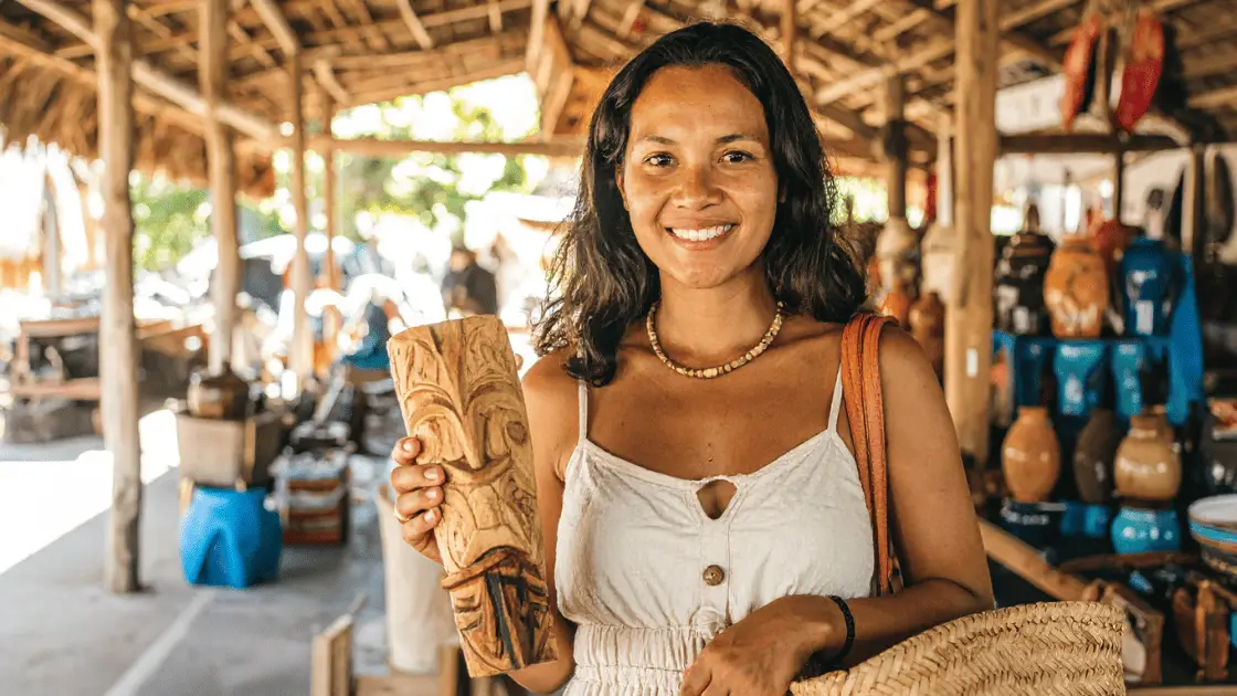Traveler supporting bali eco tourism by shopping local crafts in a Balinese village market