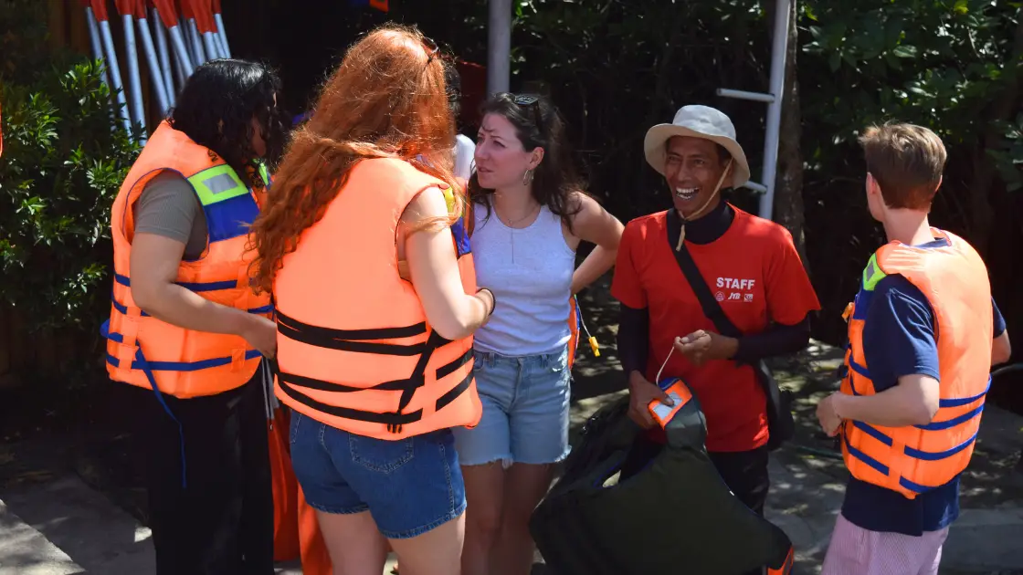 Tour guide giving safety briefing with life jackets before Bali mangrove canoe tour